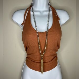 Long gold and clear bead tassel necklace.